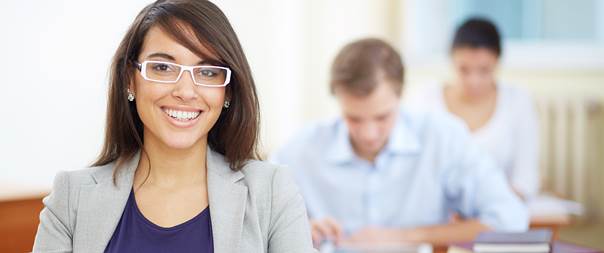 Close up of smiling female sitting in a classroom